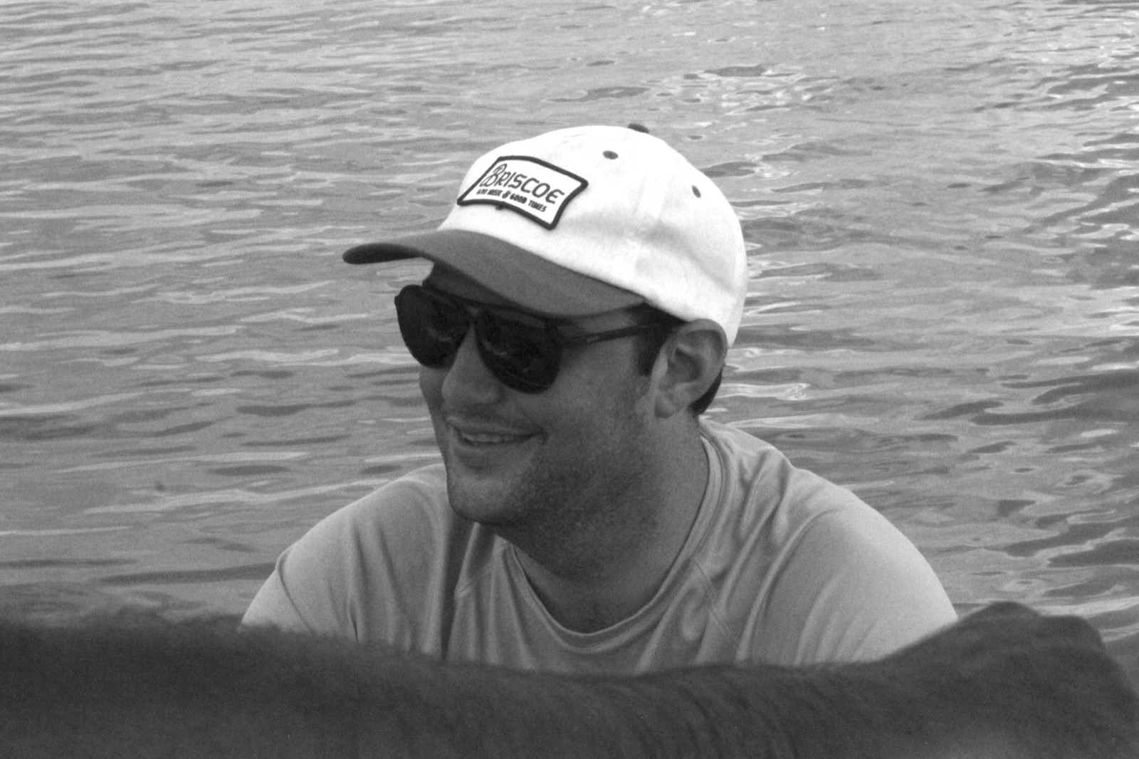 Angler in sunglasses beside the water