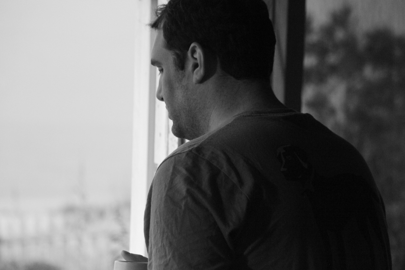 Backlit portrait at a coastal window